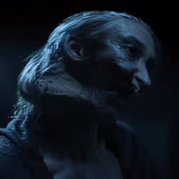 a face of zombie with big teeth and fangs