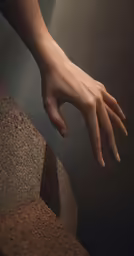 a hand reaching towards a stone pillar, in this artistic painting