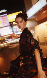 a woman wearing a black dress and heels posing for the camera