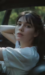 asian woman sitting down in the drivers seat of a car
