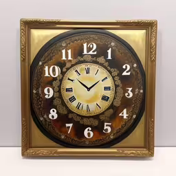 a decorative clock mounted to the wall with gold accents,this is a clock that looks like it has numbers