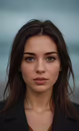 a beautiful woman with a brown shirt and blue eyes