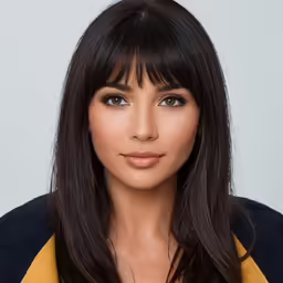the brunette girl with a long bob is posing for a studio shot