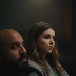 a man and woman in a dark room