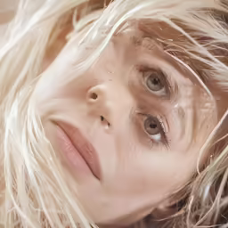 a close up of a woman with long hair and brown eyes