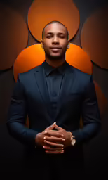 young man in black suit with a watch and dark background