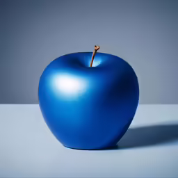 an apple is shown in the middle of a blue surface