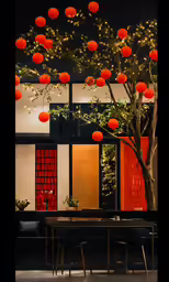 several orange paper lanterns hang from the ceiling