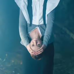 a person upside down holding their hands in front of them