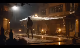 a person stands at an empty street in the snow at night