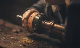 a man is drilling wood with a drilling tool