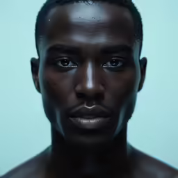 the black man is showing the skin on his face