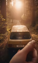 person holding the hand of a car parked on the side of a road