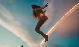 woman jumping into the air with an airplane in the background