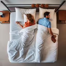 a man and woman are sitting in bed