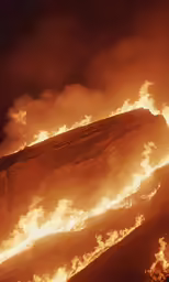 a fire is shown on a hillside covered in flames