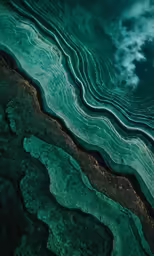 an underwater picture shows the waves in green and teal water
