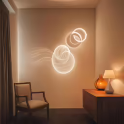 a living room that has lights on the wall