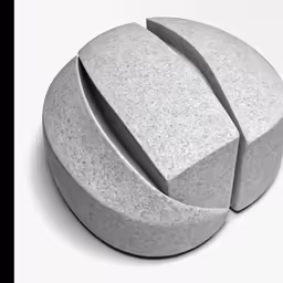 an artistic piece of concrete sitting in front of a white backdrop