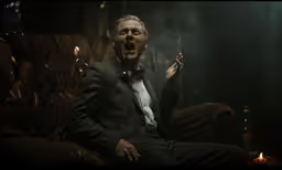 the man in the suit is smoking a cigarette