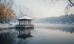 small shelter by a lake on a snowy day