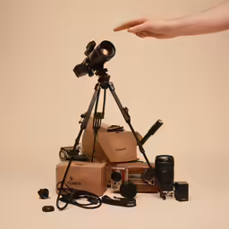 a person is holding a camera with boxes and equipment