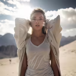 woman with wind blown hair posing for camera outdoors