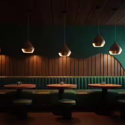 three benches along the wall are made up of velvety green and light wood