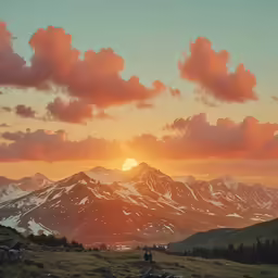 the sun sets behind snowy mountains in the distance