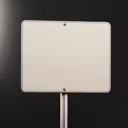 a blank white street sign sitting on top of a metal pole