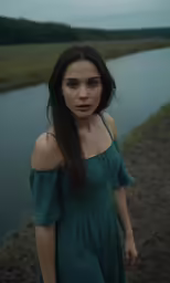 an attractive young woman standing in front of a lake