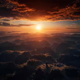 the sun is setting above some mountains