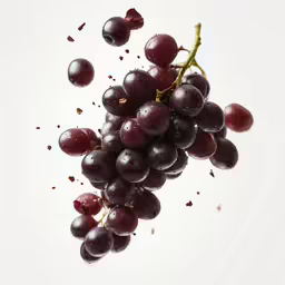 grapes flying in the air next to each other