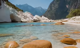 a sandy beach with large rocks sitting on the shore