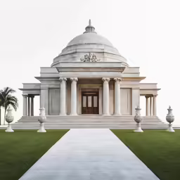 a building with steps and pillars that lead up to the door