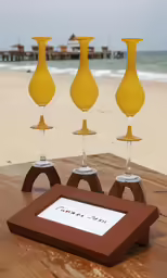 a table is covered with four yellow vases