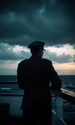 a man looking over the top of the deck at the ocean