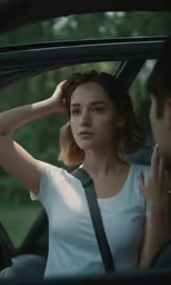 young woman sitting in the passenger seat of her car as she sits on her own side, touching her hair and looking off to the left