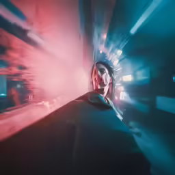 the woman has her eyes closed and looks towards something