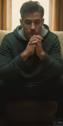 young man sitting down and begging for assistance