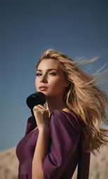 a woman standing with long hair blowing through her blow dryer