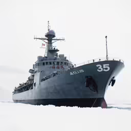 the large battleship is in deep snow, with two people on it