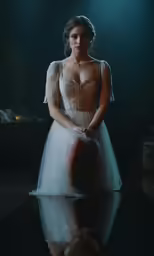 a woman sitting on the ground in a dress