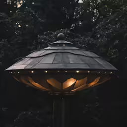 a lamp post outside with lights shining on it