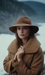 a woman wearing a brown coat and hat