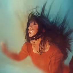 a woman with her hair in the wind