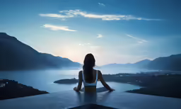 a woman sitting on a ledge overlooking the mountains