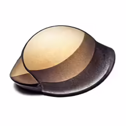 a brown bowl with an orange handle is shown