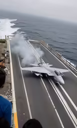 an airplane on an aircraft carrier on an ocean