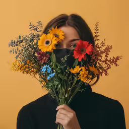 a girl wearing a mask hiding her face behind a bunch of flowers